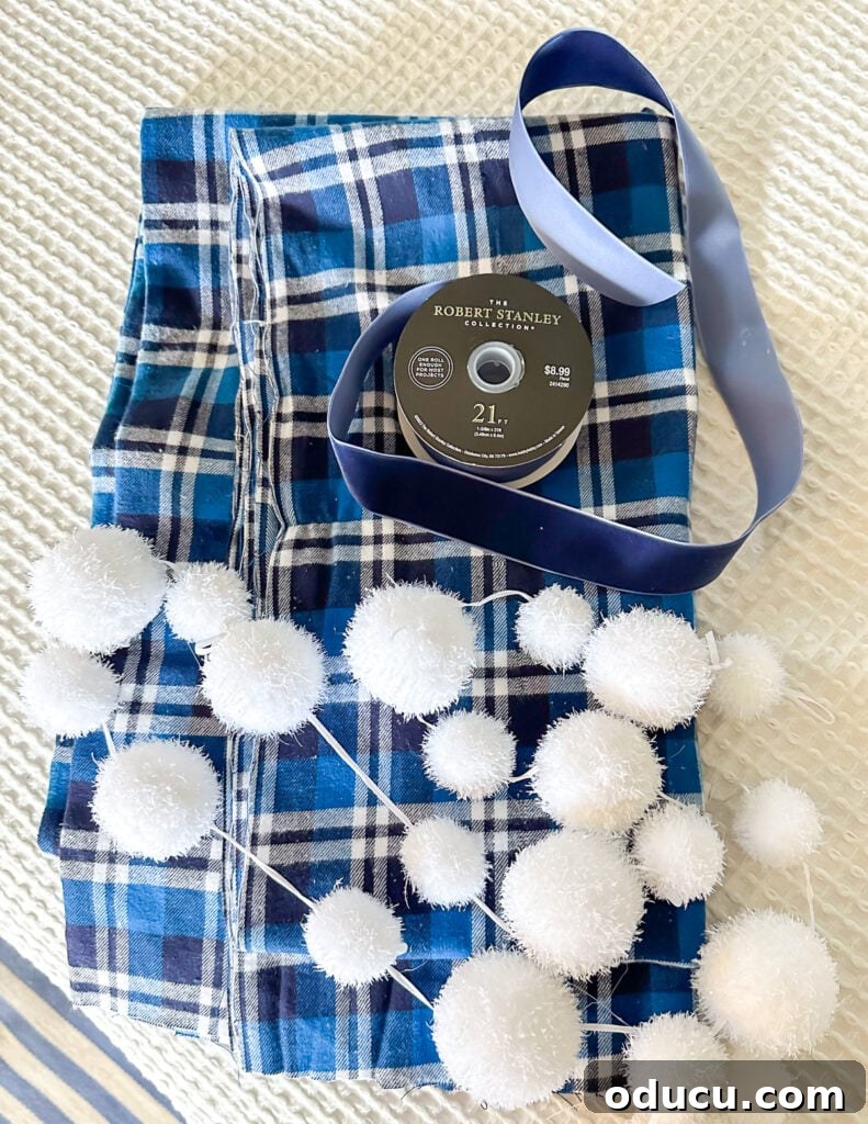 The King of My Christmas 12 blue and white plaid fabric, blue ribbon and snowball garland.