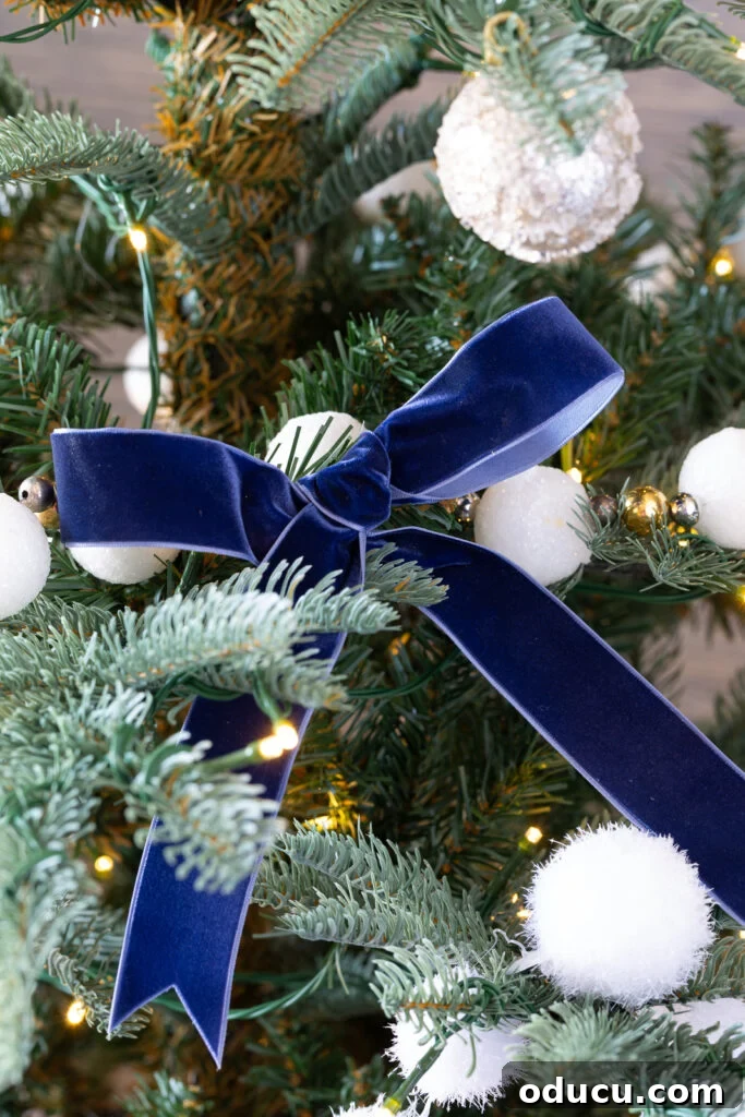 The King of My Christmas 15 blue velvet bow on a King of Christmas artificial Christmas tree.