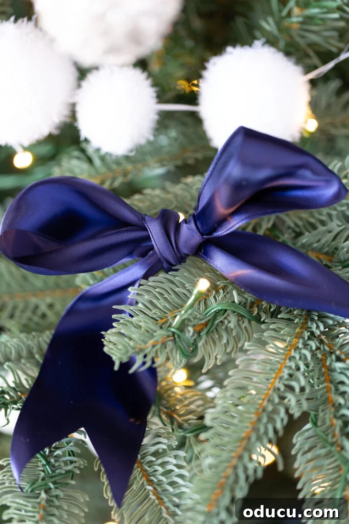The King of My Christmas 16 blue satin bow on a King of Christmas artificial Christmas tree.