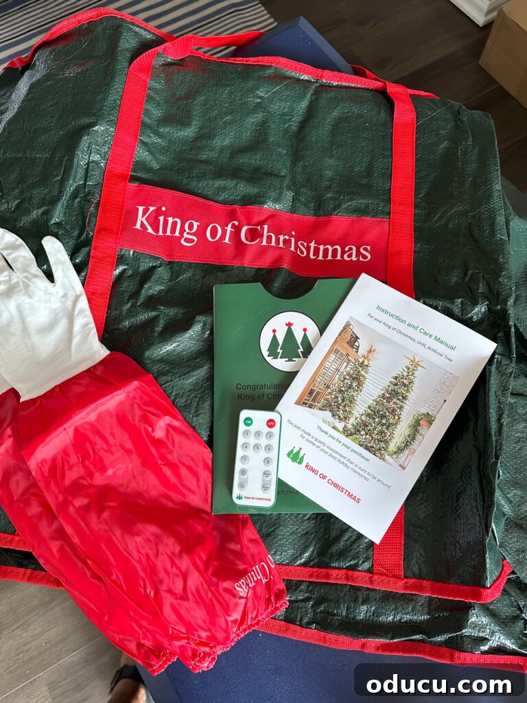 The King of My Christmas 3 King of Christmas Christmas tree storage bag, tree fluffing gloves and remote control for lights.
