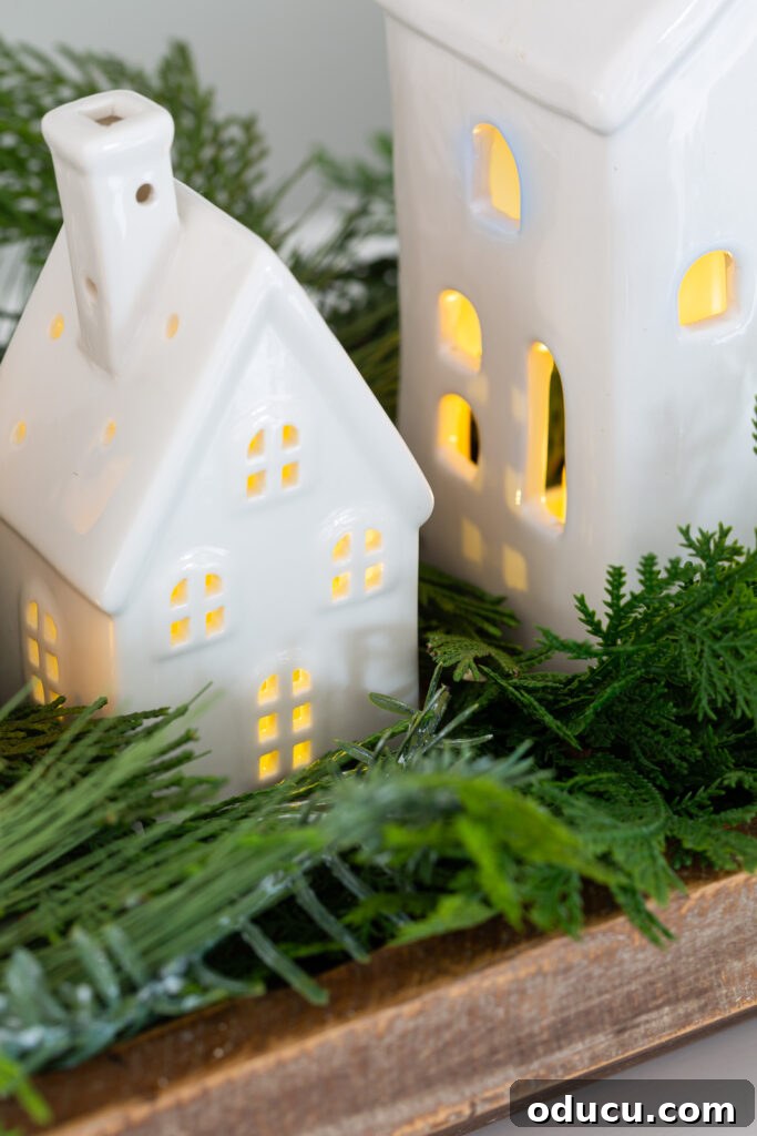 Tealight Village Magic: Fall and Holiday Decor 12 Elegant white tealight houses beautifully arranged for classic Christmas decor, radiating a warm and inviting glow.