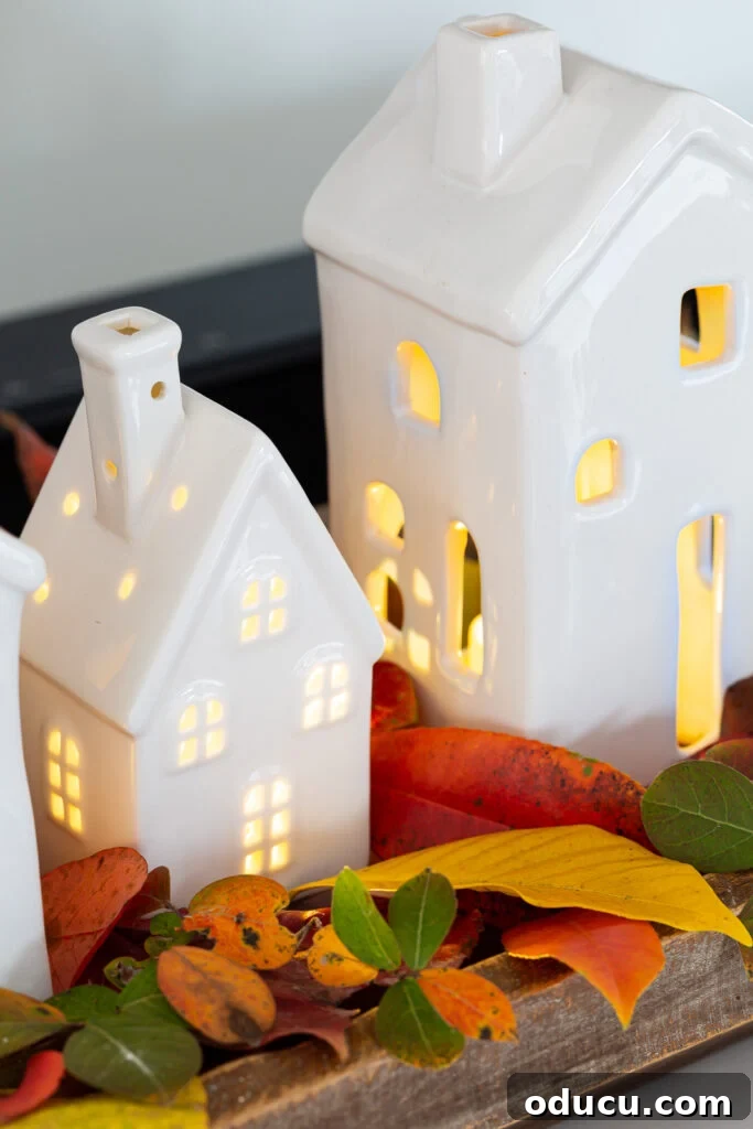 Tealight Village Magic: Fall and Holiday Decor 8 A beautiful arrangement of light-up ceramic village houses displayed for both fall and Christmas decor, showcasing seasonal versatility.