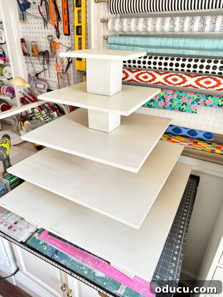 Adventures in Life and Home 12 A beautifully refurbished white tiered donut stand, ready for a wedding dessert table.