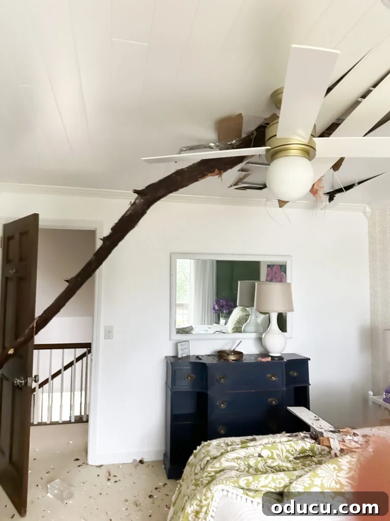 Adventures in Life and Home 3 Guest bedroom with the ceiling completely opened up, showing exposed rafters and debris after a tree broke through the roof.
