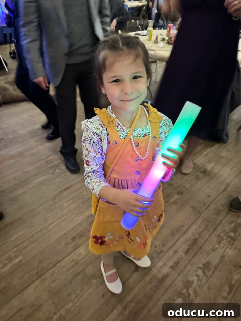 Mandy Ties the Knot 24 Flower girl dancing with a foam glow stick