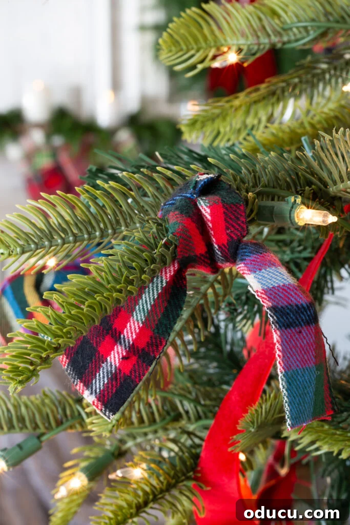 Decking the Halls for the Holidays 10 Red plaid flannel fabric strip tied onto a Christmas tree branch.