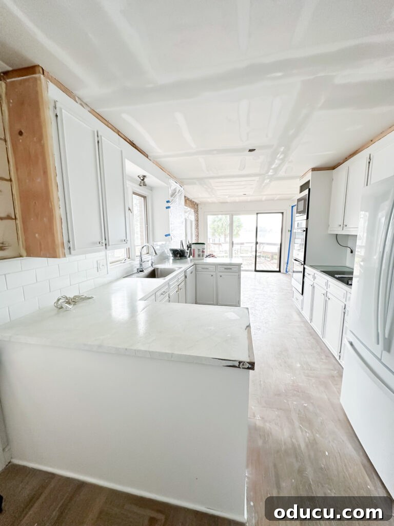 My Kitchen's Stunning Spacious Makeover 11 Kitchen after popcorn ceiling removal, showing smooth new ceiling and remaining upper wall cabinets.