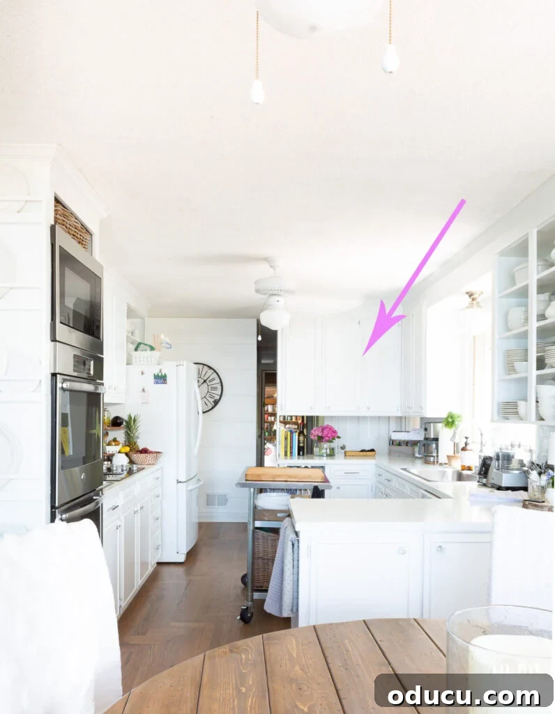 My Kitchen's Stunning Spacious Makeover 3 Kitchen showing a section of outdated upper wall cabinets slated for removal to create an open concept.