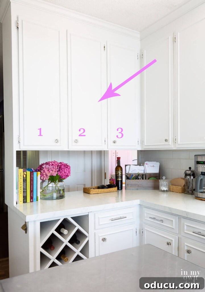My Kitchen's Stunning Spacious Makeover 5 Highlighted section of three upper wall cabinets in a kitchen, targeted for removal to open up the space.