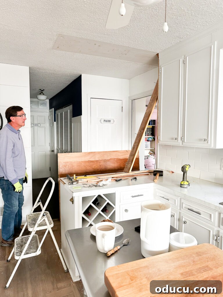 My Kitchen's Stunning Spacious Makeover 8 Kitchen space after old upper cabinets have been completely removed from the wall and ceiling, revealing an open layout.