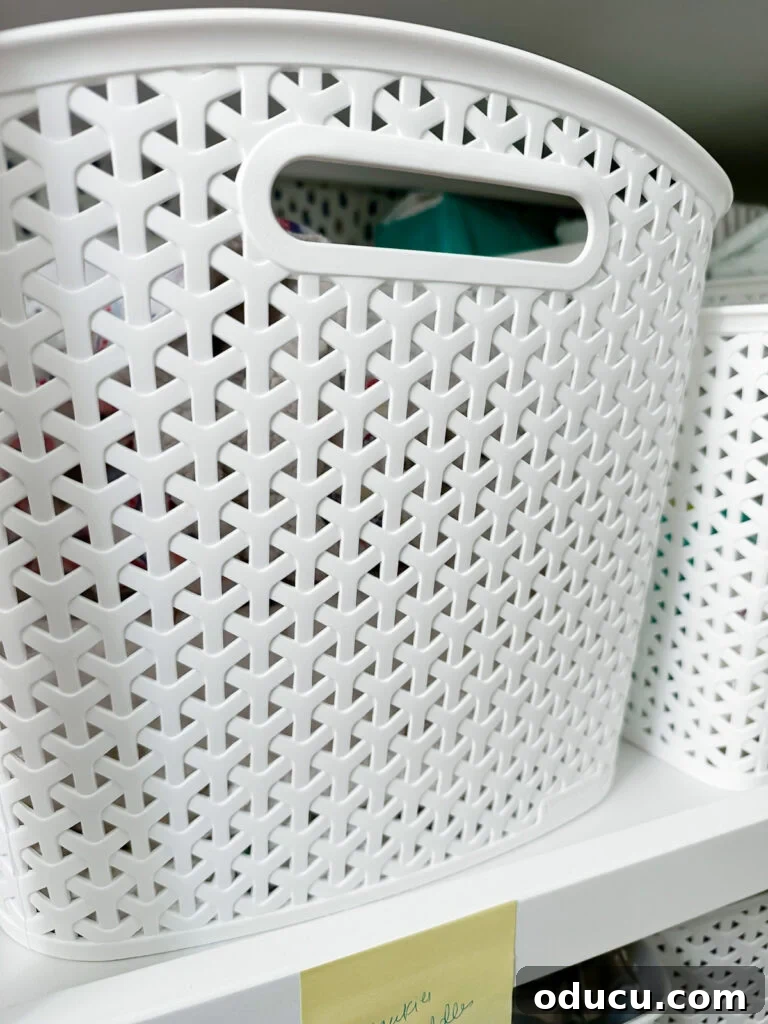 Elevate Your Nursery: Printable Basket Labels for Stylish Organization 3 Close-up of a stylish white plastic storage basket, perfect for nursery organization