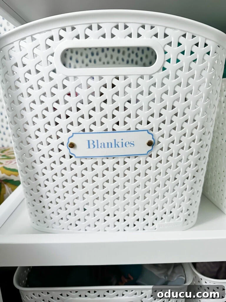 Elevate Your Nursery: Printable Basket Labels for Stylish Organization 7 Detailed view of a personalized blue and white nursery label on a white plastic basket