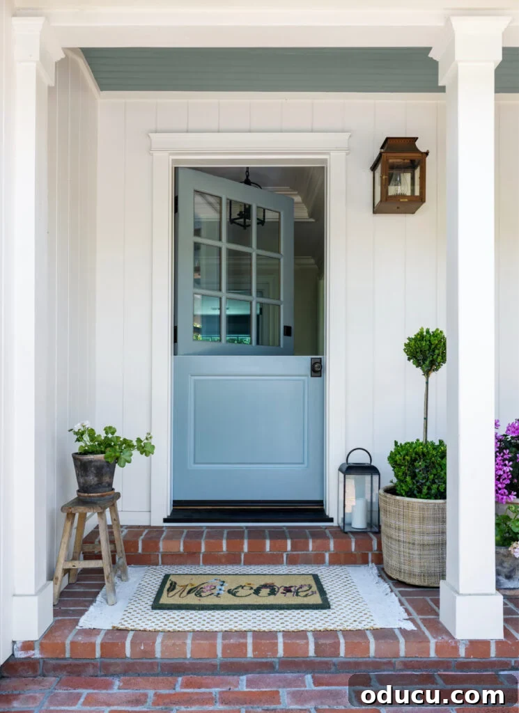 A charming blue Dutch door at the entry of a home, inviting and stylish, hinting at a beautiful interior renovation.