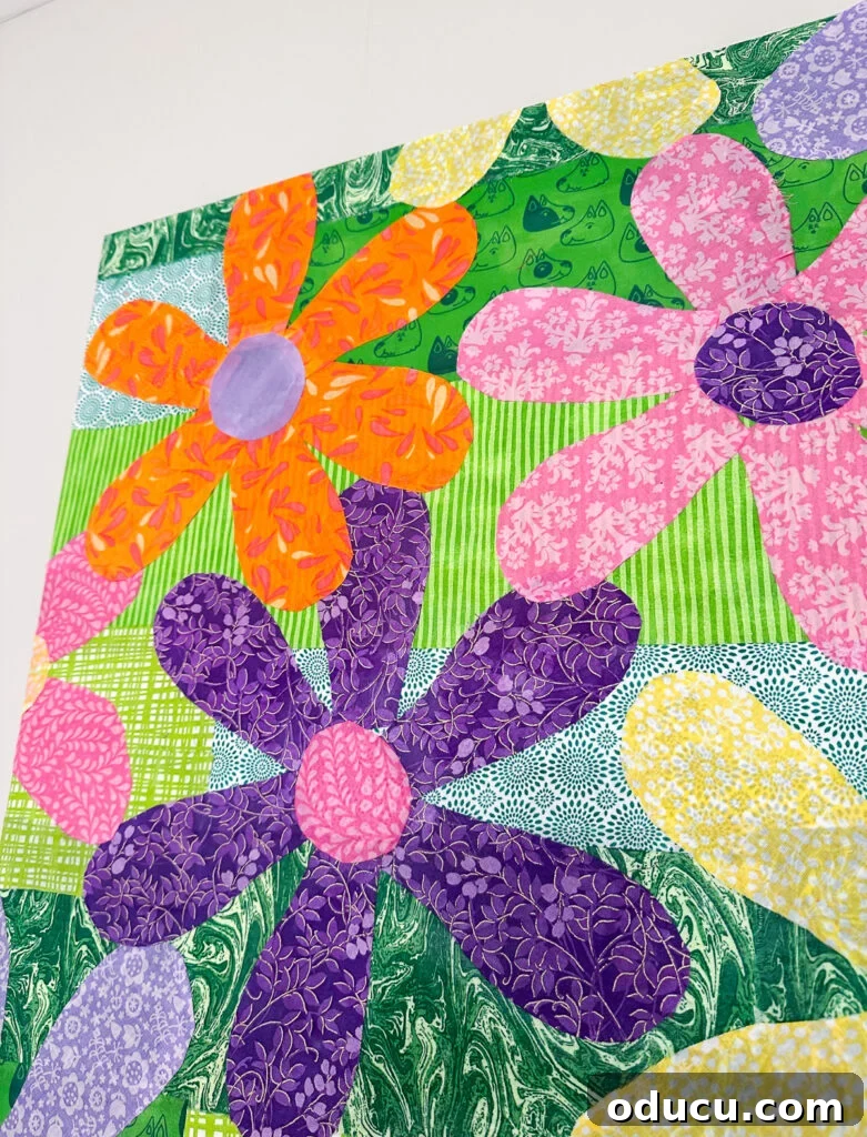 close up of colorful fabric flowers Mod Podged on a repurposed canvas