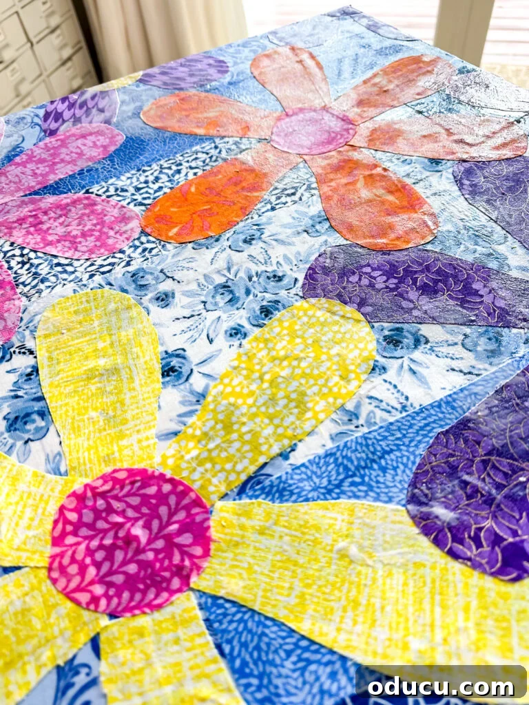 Attaching cut-out fabric flowers to canvas