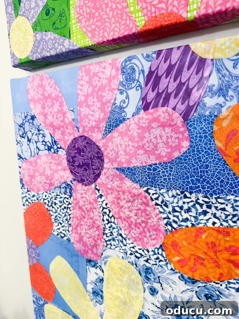 close up of colorful fabric flowers Mod Podged on a repurposed canvas