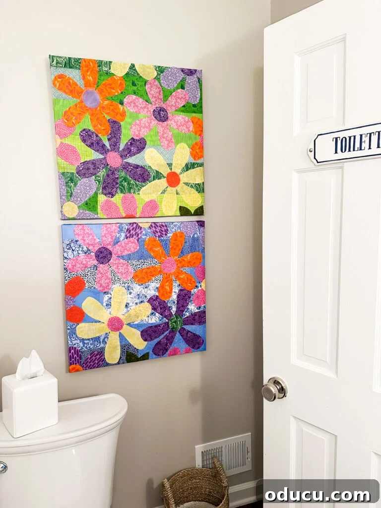 Two repurposed artist's canvases covered in cut out fabric flowers.